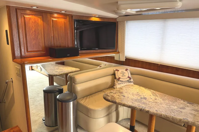 Slide: The Image of Luxurious interior of a 1991 Viking 53 Convertible yacht with beige leather seating and wooden accents. - 30