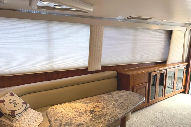 Slide: The Image of Luxurious interior of a 1991 Viking 53 Convertible yacht with elegant wood finishes. - 31