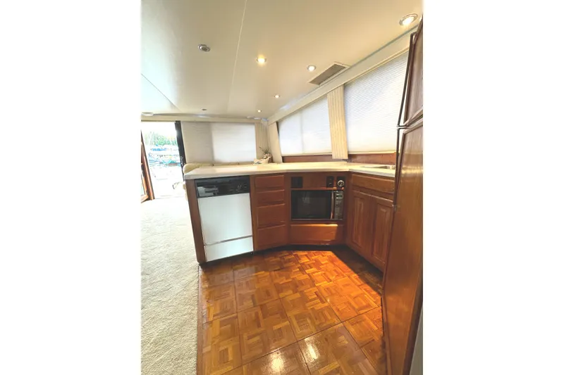 Slide: The Image of Luxurious interior of 1991 Viking 53 Convertible yacht with beige leather seating. - 36