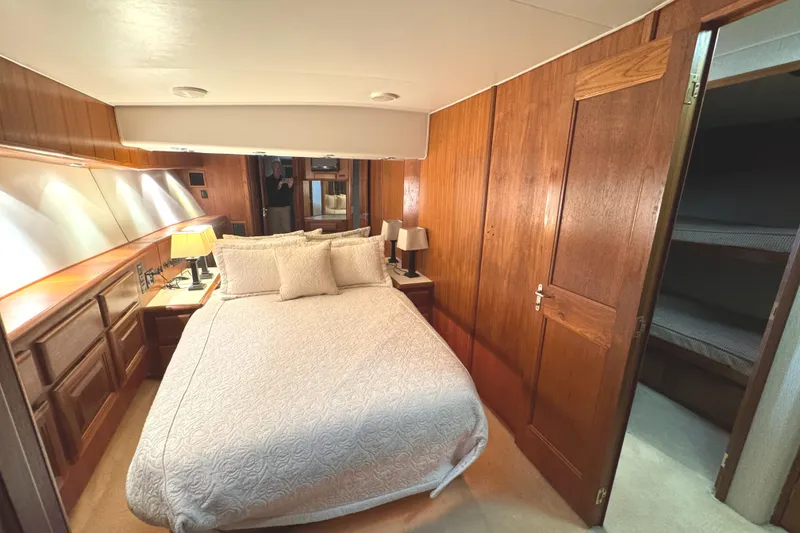 Slide: The Image of 1991 Viking 53 Convertible cabin with cozy bunk beds and wooden interior. - 42