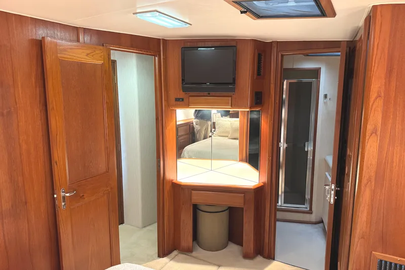 Slide: The Image of Luxurious bedroom interior of 1991 Viking 53 Convertible yacht with wood paneling and skylight. - 44