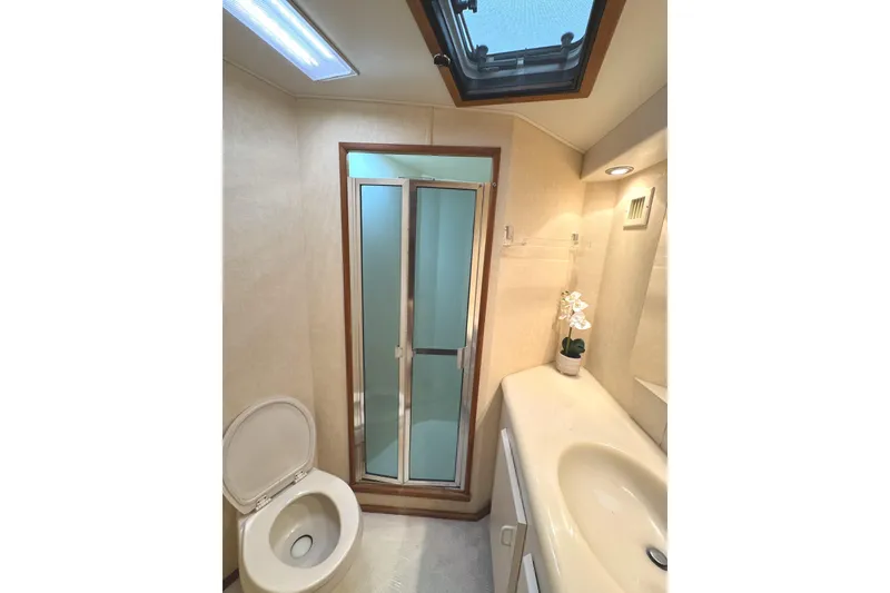 Slide: The Image of Interior of 1991 Viking 53 Convertible yacht with wood paneling and modern amenities. - 46