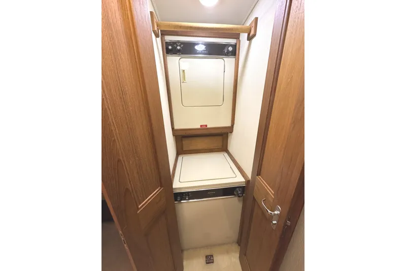 Slide: The Image of Interior of 1991 Viking 53 Convertible yacht with wood paneling and TV. - 47