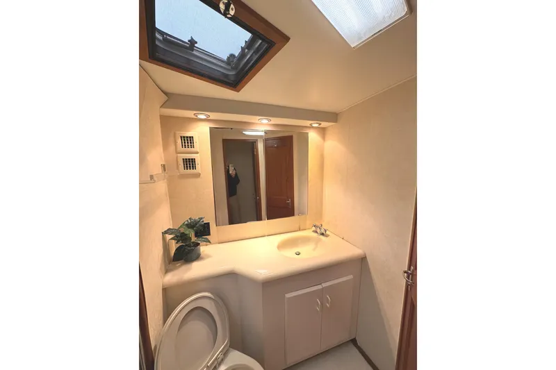 Slide: The Image of Laundry area in 1991 Viking 53 Convertible yacht with wood paneling and compact washer-dryer. - 50