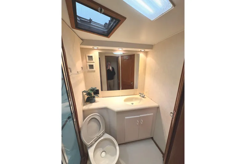 Slide: The Image of Bathroom interior of 1991 Viking 53 Convertible yacht with shower and skylight. - 51