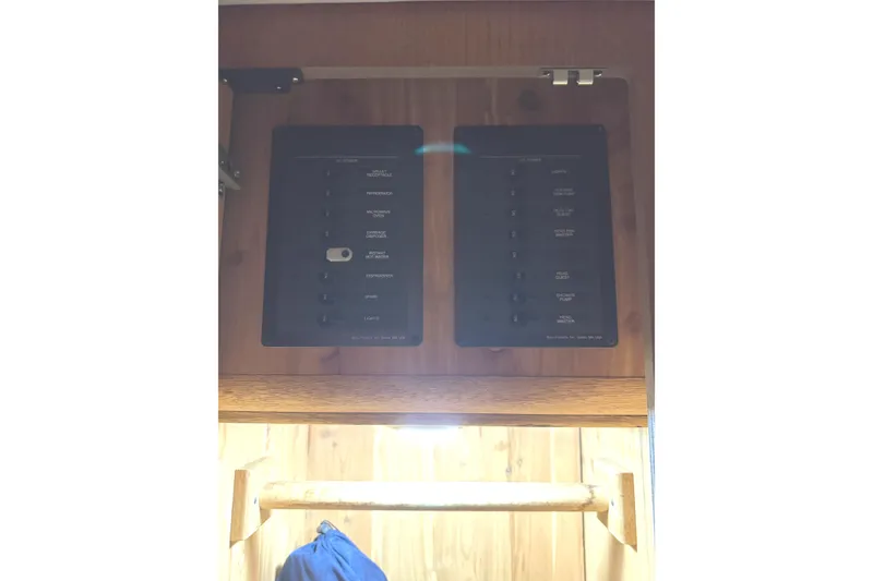 Slide: The Image of Interior cabin of 1991 Viking 53 Convertible yacht with wood paneling and striped bedding. - 58