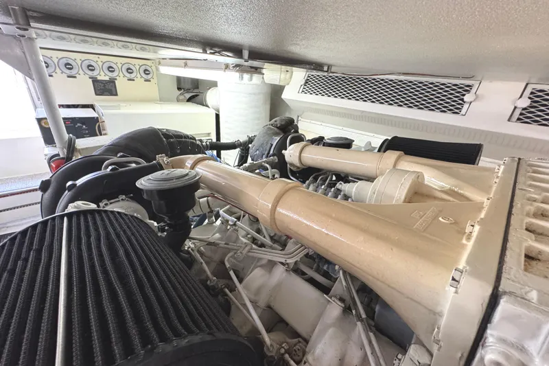 Slide: The Image of Engine room of a 1991 Viking 53 Convertible yacht, showcasing control panel and machinery. - 67