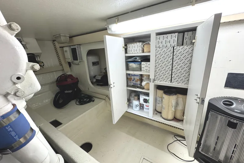 Slide: The Image of Engine room of a 1991 Viking 53 Convertible yacht, showcasing a powerful marine engine. - 68