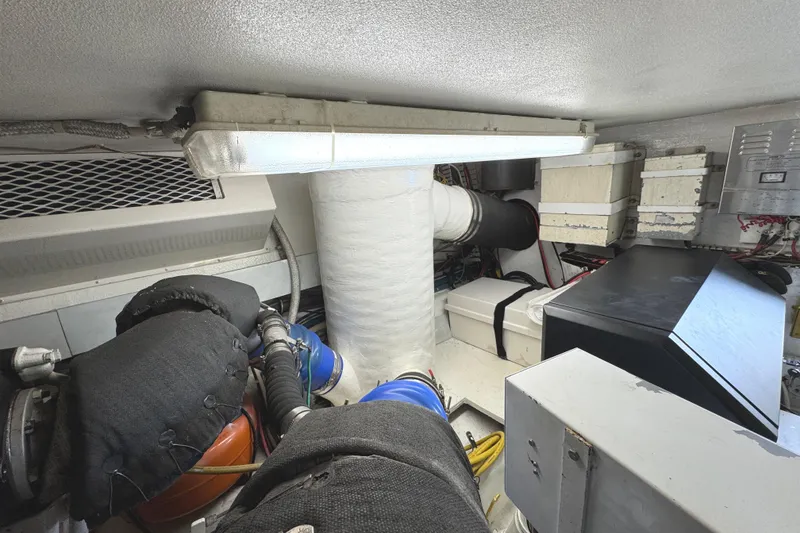 Slide: The Image of Engine room of a 1991 Viking 53 Convertible yacht with fire extinguisher and equipment. - 72