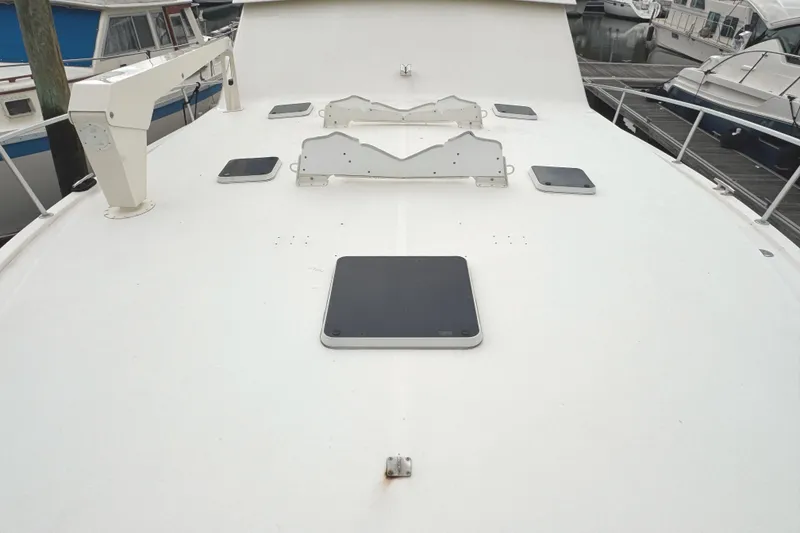 Slide: The Image of Bow of 1991 Viking 53 Convertible yacht with anchor chain and winch. - 82