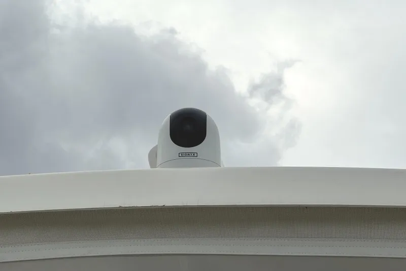 Slide: The Image of 1991 Viking 53 Convertible yacht docked at marina under cloudy skies. - 86