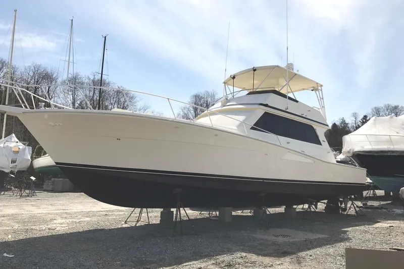 Slide: The Image of 1991 Viking 53 Convertible yacht on dry dock, side view under clear sky. - 89