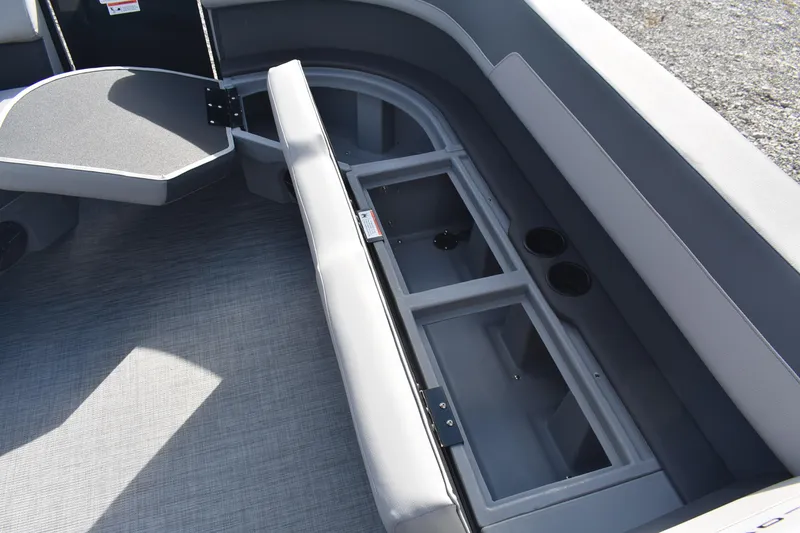 Slide: The Image of 2026 Lowe LS 210 boat interior with open storage compartments and seating area. - 11
