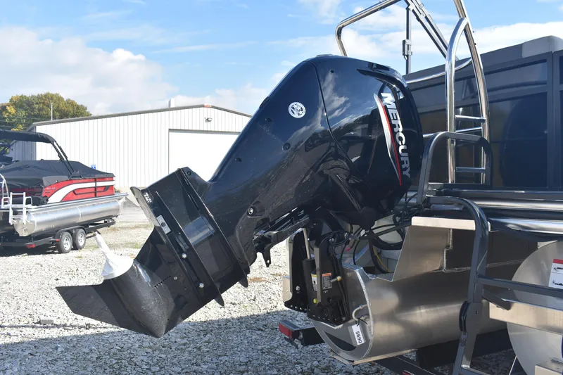 Slide: The Image of 2026 Lowe LS 210 boat with Mercury outboard motor in a marina setting. - 5