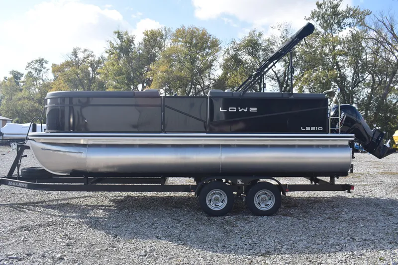 Slide: The Image of 2026 Lowe LS 210 pontoon boat on trailer, parked outdoors. - 9