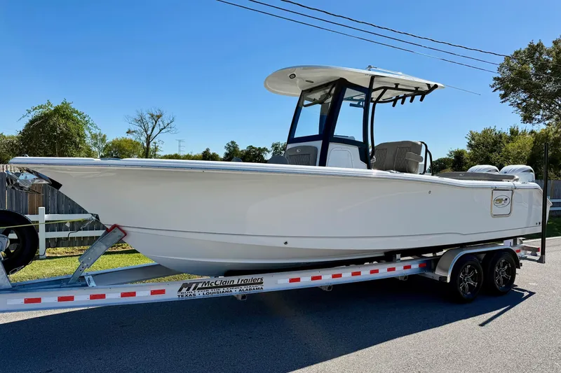 The Image of 2026 Sea Hunt Ultra 265 SE boat on trailer, parked outdoors. - 1