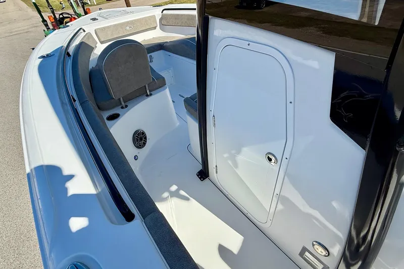 Slide: The Image of 2026 Sea Hunt Ultra 265 SE boat interior with seating and storage compartment. - 12