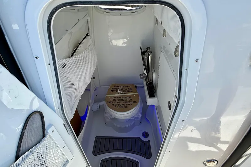 Slide: The Image of 2026 Sea Hunt Ultra 265 SE boat interior with compact marine toilet. - 13