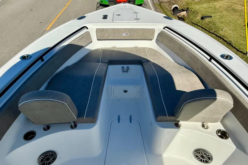 Slide: The Image of 2026 Sea Hunt Ultra 265 SE boat interior with cushioned seating and cup holders. - 14