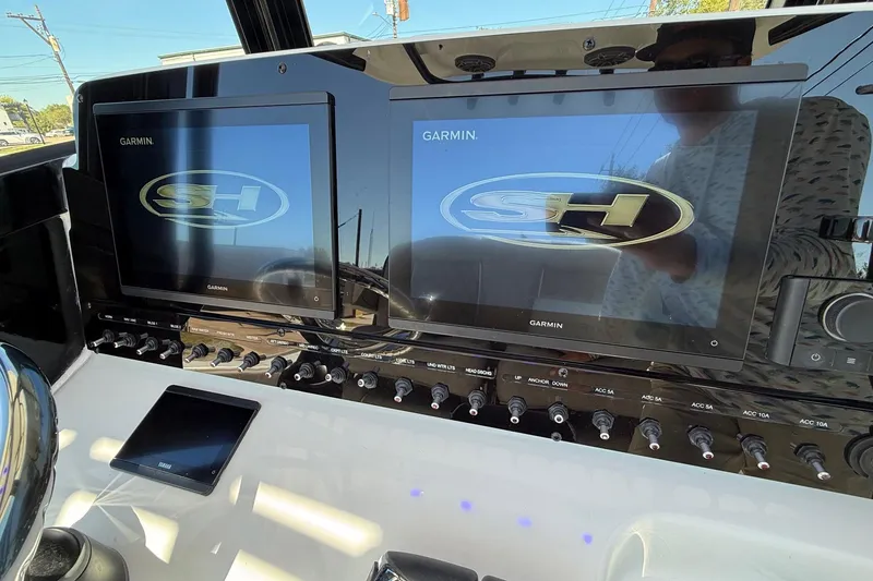 Slide: The Image of Dashboard of 2026 Sea Hunt Ultra 265 SE with dual Garmin displays. - 17