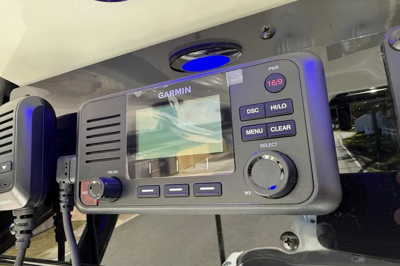 Slide: The Image of Garmin marine radio on 2026 Sea Hunt Ultra 265 SE boat dashboard. - 19