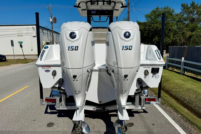 Slide: The Image of 2026 Sea Hunt Ultra 265 SE with twin Yamaha 150 outboard engines on a trailer. - 3