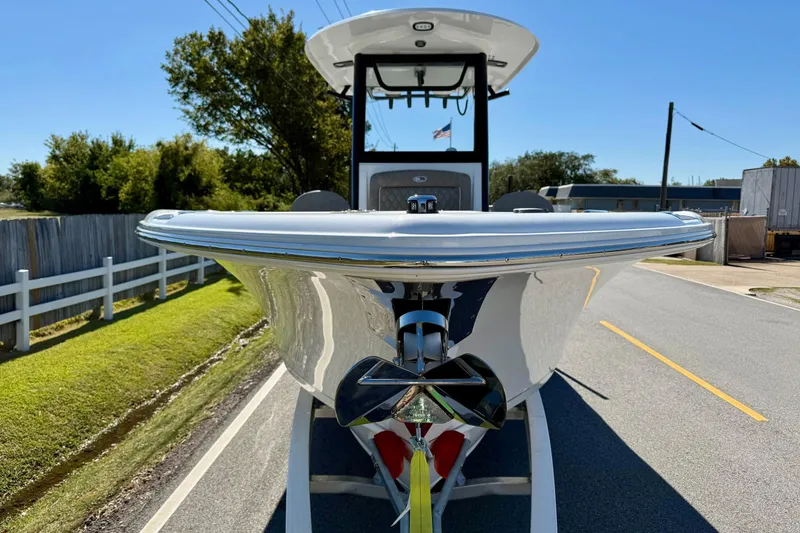 Slide: The Image of 2026 Sea Hunt Ultra 265 SE boat on trailer, front view, sunny day. - 6