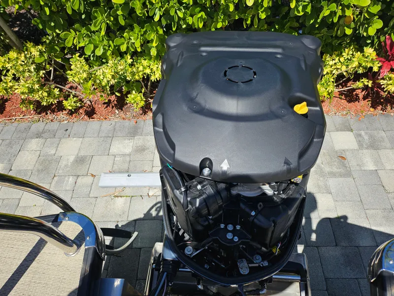 Slide: The Image of Top view of a 2020 Godfrey Sanpan 2400 SBC boat engine, surrounded by greenery. - 15