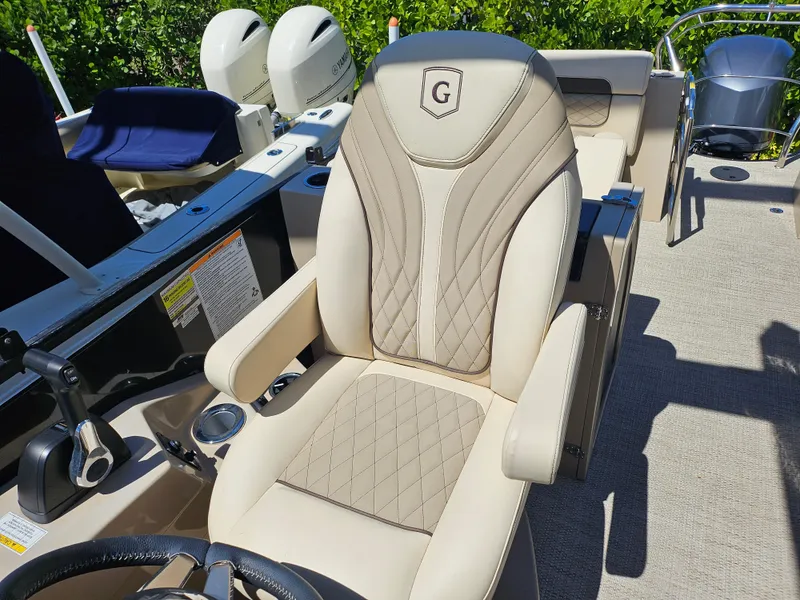 Slide: The Image of 2020 Godfrey Sanpan 2400 SBC boat seat with luxurious beige upholstery and steering wheel. - 26