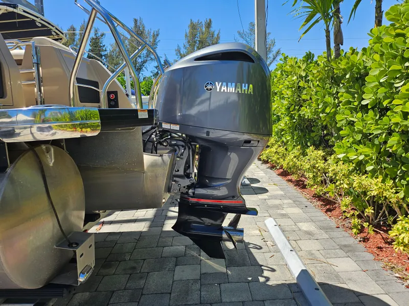 Slide: The Image of 2020 Godfrey Sanpan 2400 SBC with Yamaha outboard motor, parked on a sunny day. - 30