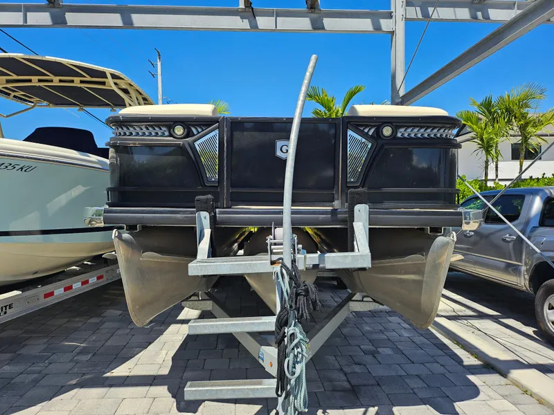 Slide: The Image of 2020 Godfrey Sanpan 2400 SBC pontoon boat on trailer, parked outdoors. - 35