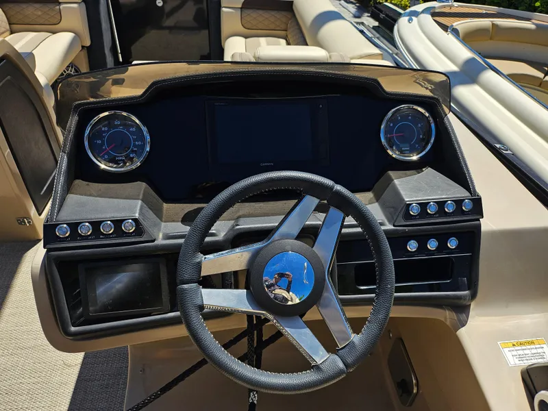 Slide: The Image of 2020 Godfrey Sanpan 2400 SBC boat dashboard with steering wheel and gauges. - 4