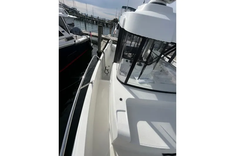 Slide: The Image of 2020 Beneteau Barracuda 9 docked, showcasing sleek design and spacious deck area. - 6