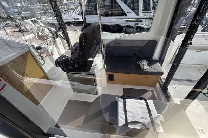 Slide: The Image of Interior view of 2020 Beneteau Barracuda 9 boat, featuring seating and helm area. - 7