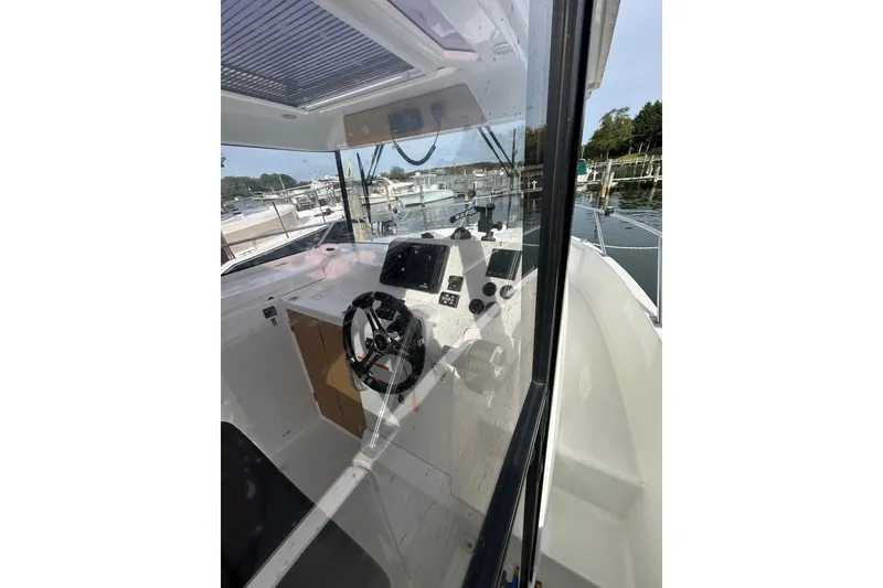 Slide: The Image of Interior view of 2020 Beneteau Barracuda 9 boat cockpit with steering wheel and controls. - 8