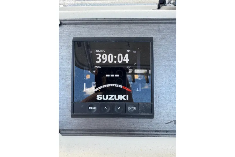 Slide: The Image of Suzuki engine display showing 390 hours on 2002 Aquasport 225 Osprey boat. - 11