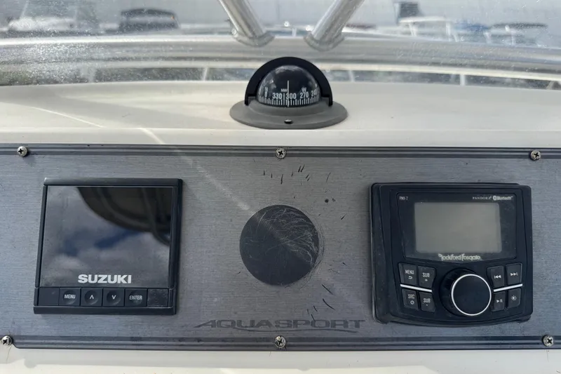 Slide: The Image of Dashboard of a 2002 Aquasport 225 Osprey with Suzuki and Rockford Fosgate controls. - 12