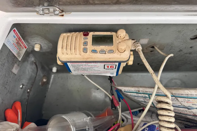 Slide: The Image of VHF marine radio in a 2002 Aquasport 225 Osprey boat compartment. - 13