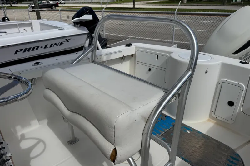 Slide: The Image of 2002 Aquasport 225 Osprey boat interior with seating and storage compartments. - 14