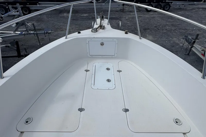 Slide: The Image of 2002 Aquasport 225 Osprey boat deck with storage compartments and railing. - 15