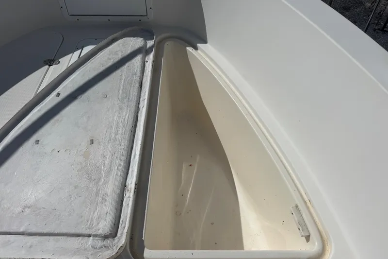 Slide: The Image of Open storage compartment on 2002 Aquasport 225 Osprey boat, showing interior space. - 17