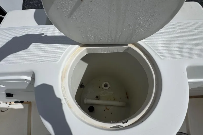 Slide: The Image of Open storage compartment on 2002 Aquasport 225 Osprey boat, showing interior details. - 21