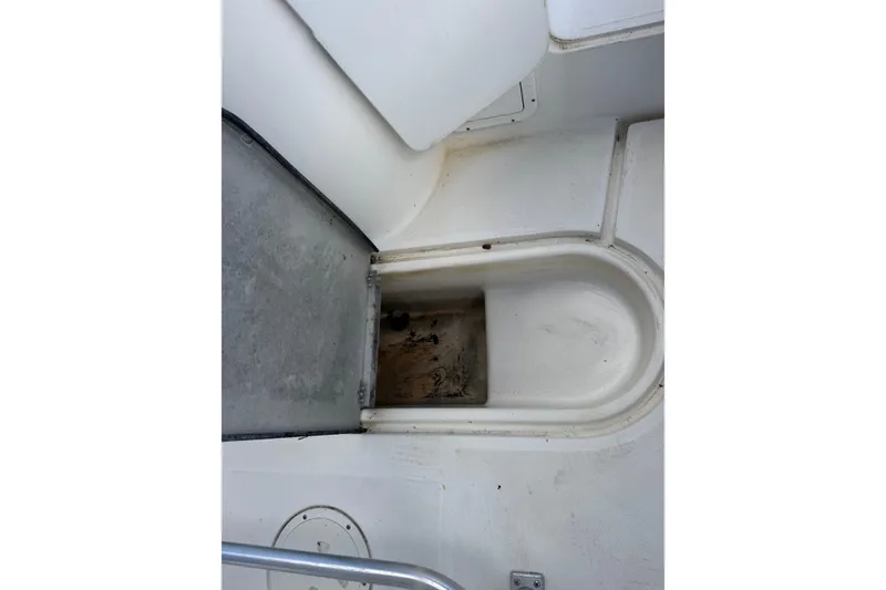 Slide: The Image of 2002 Aquasport 225 Osprey boat interior showing storage compartment and seating area. - 25