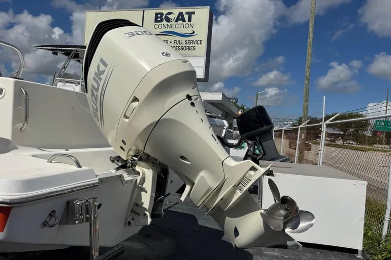 Slide: The Image of 2002 Aquasport 225 Osprey boat with Suzuki outboard motor at dealership. - 26
