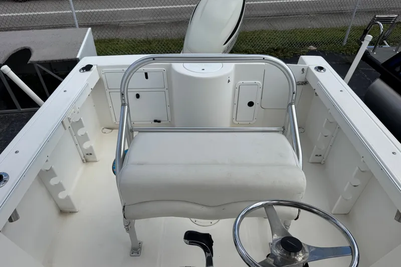 Slide: The Image of 2002 Aquasport 225 Osprey boat interior with steering wheel and seating. - 7
