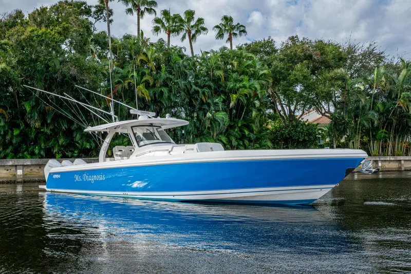 The Image of 2020 Intrepid 407 Panacea boat on water, surrounded by lush greenery. - 0