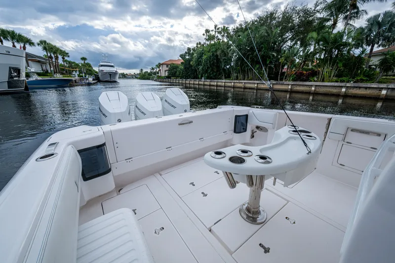 Slide: The Image of Intrepid 407 Panacea 2020 boat with fishing setup, docked in a scenic canal. - 10