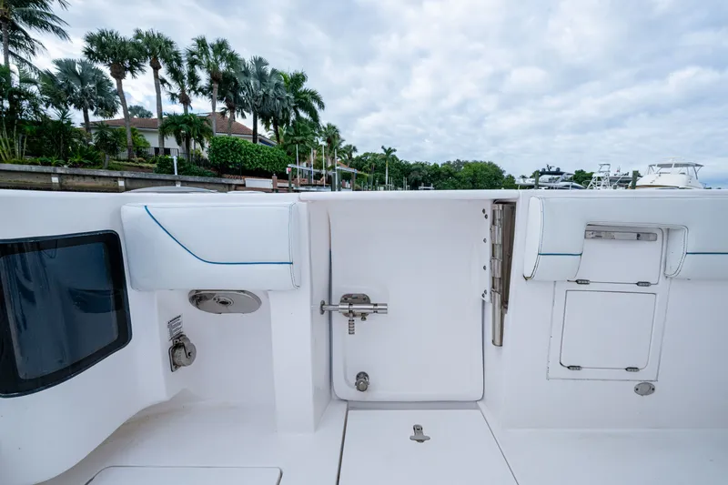 Slide: The Image of 2020 Intrepid 407 Panacea boat interior with white seating and storage compartments. - 13