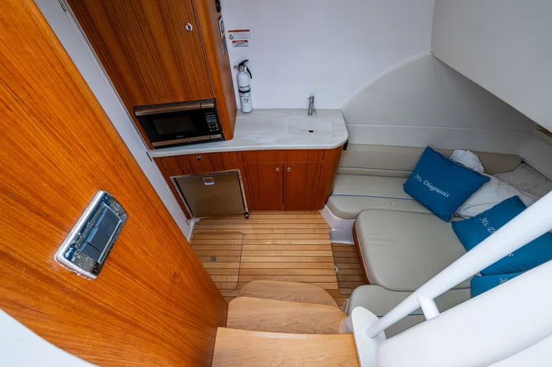 Slide: The Image of 2020 Intrepid 407 Panacea cabin interior with kitchenette, seating, and wooden flooring. - 23