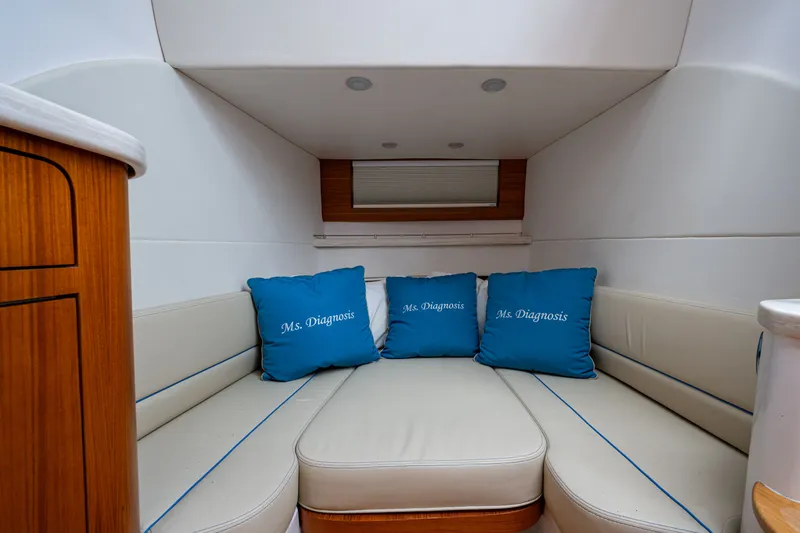 Slide: The Image of Interior of 2020 Intrepid 407 Panacea boat with blue cushions and beige seating. - 27